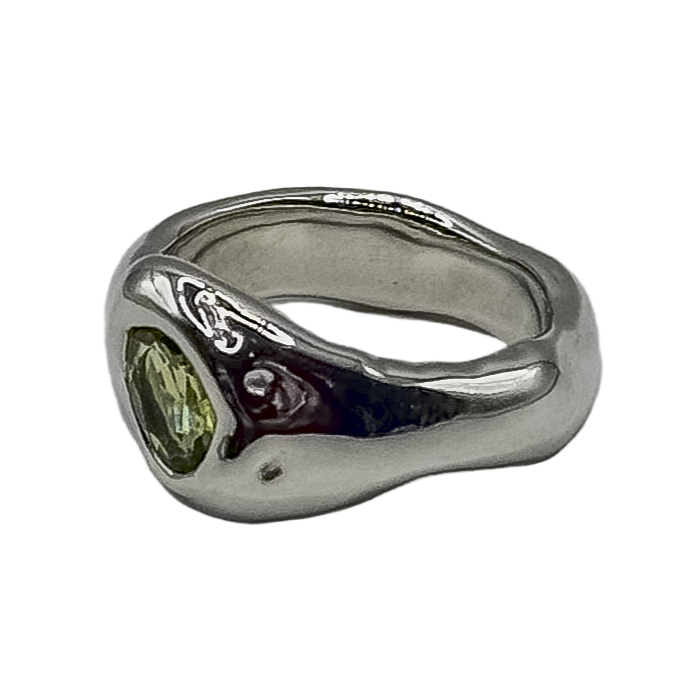 Silver ring with a green gemstone on a white background