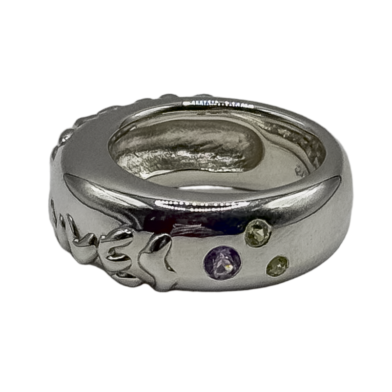 Silver ring with embedded gemstones on a white background